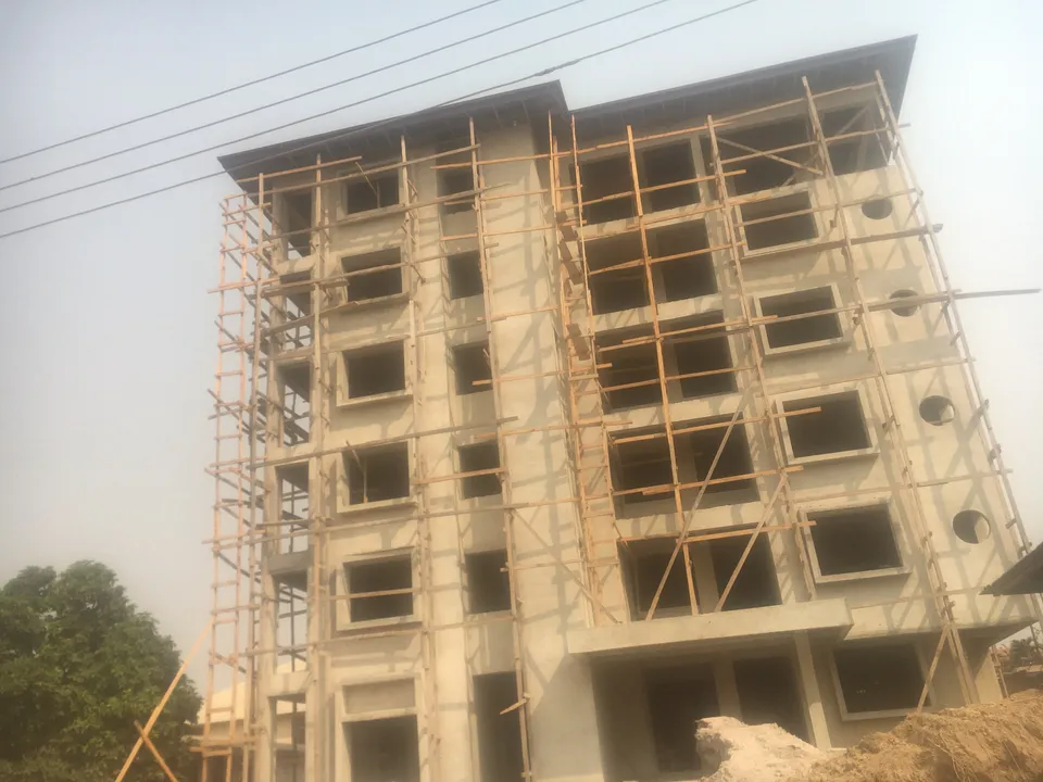 Multi-storey building under construction with scaffolding in Ghana