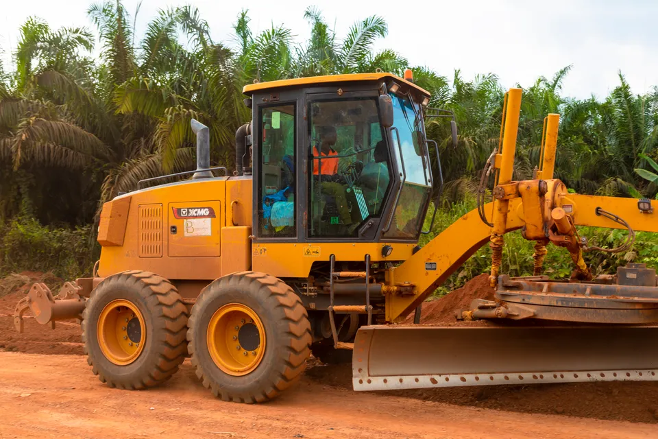 Motor grader grading a laterite road